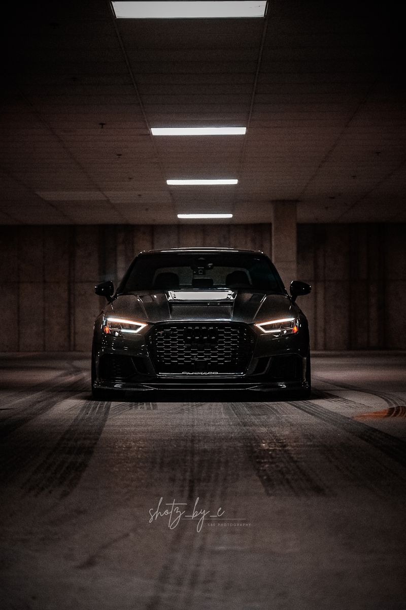 Black Audi in an empty night garage